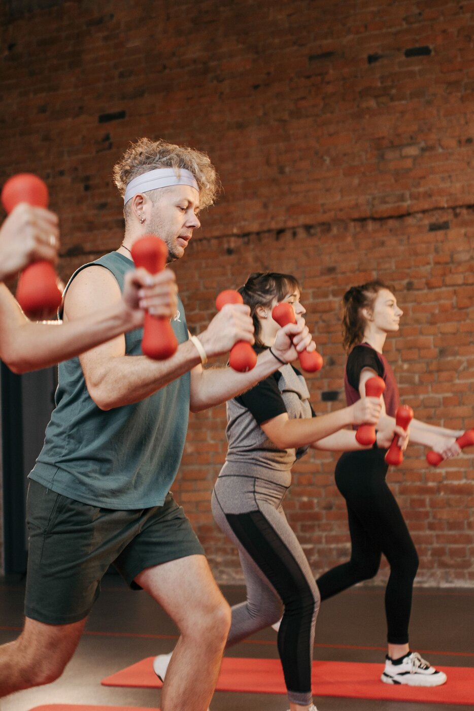 Group of friends high-fiving after a workout class